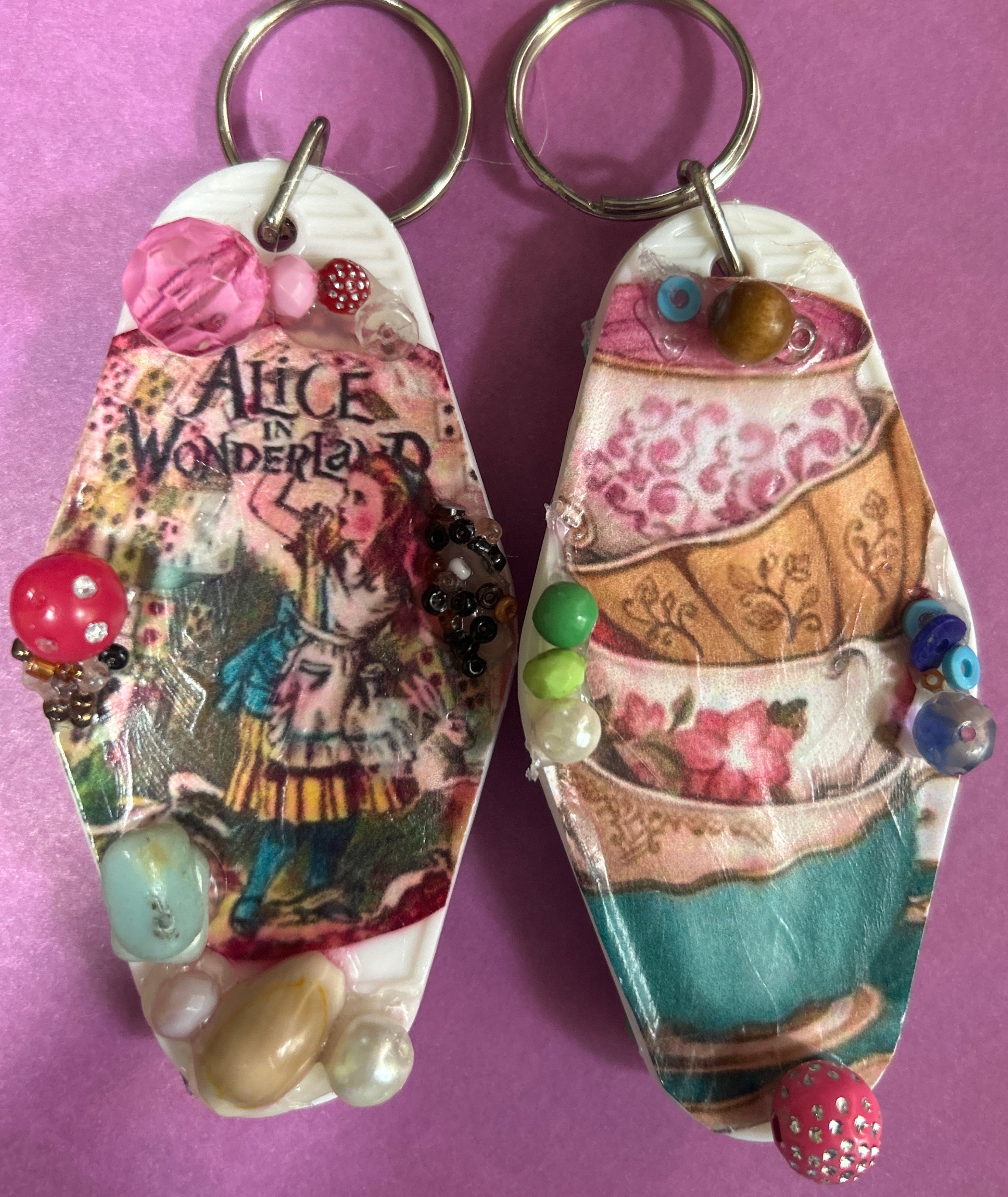 A pair of hand decorated retro motel keyrings.
