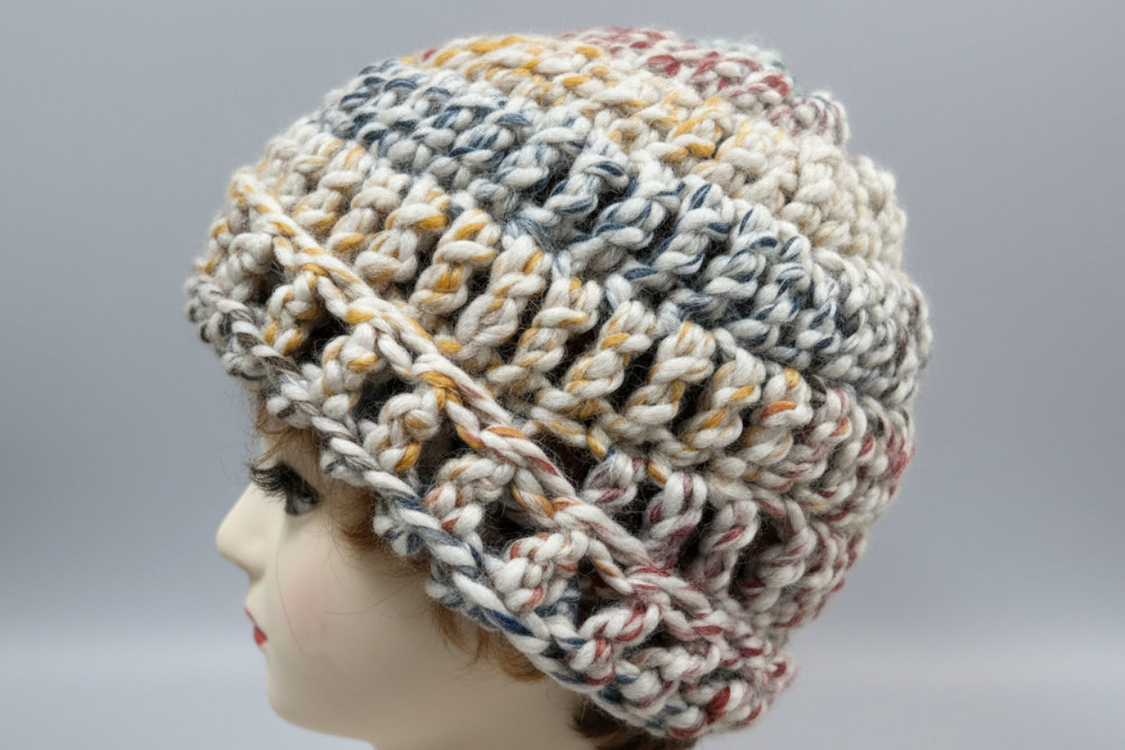Knitted hat on a mannequin head with a pink background