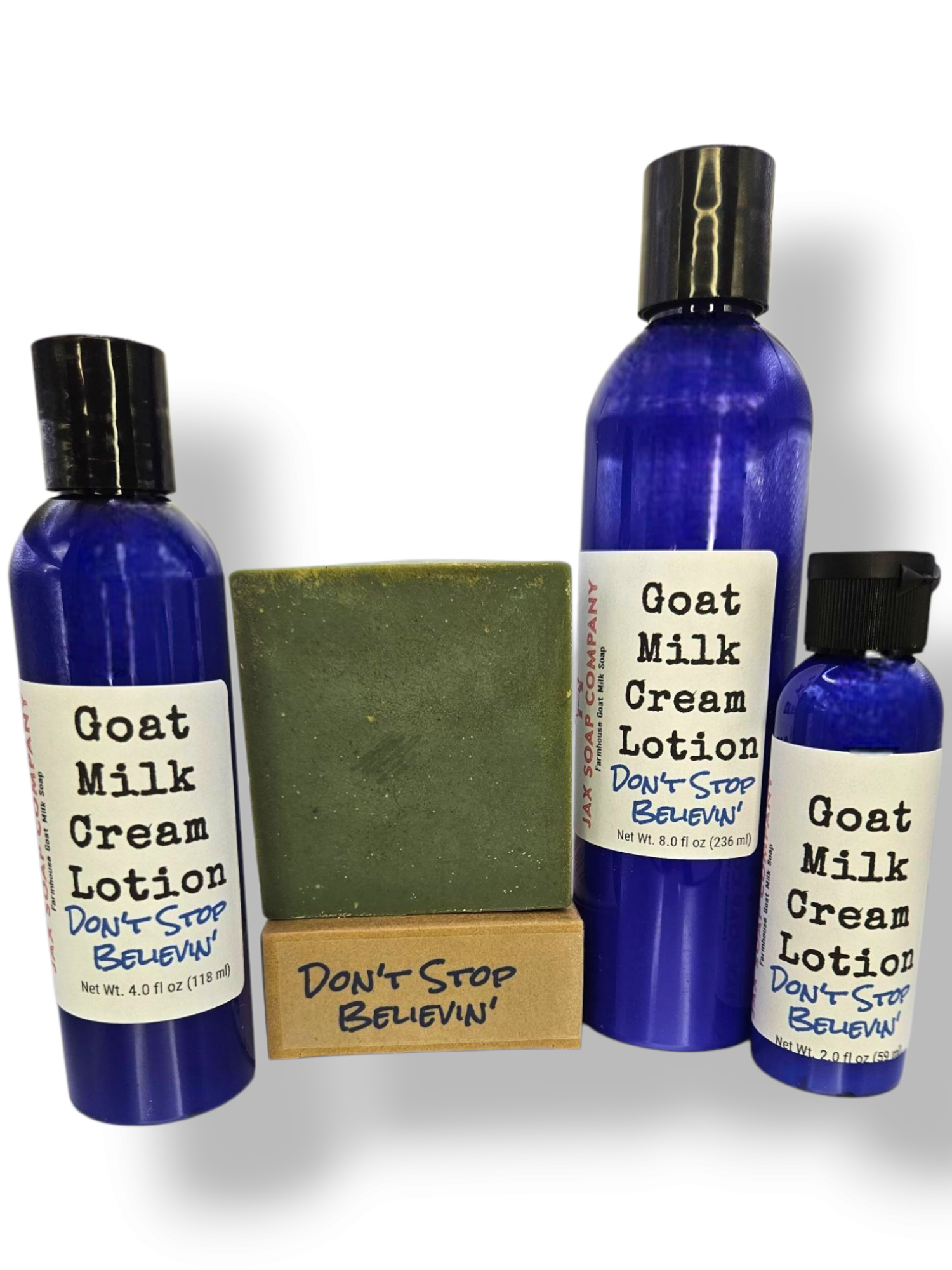 Set of Goat Milk Cream Lotion bottles and a bar of soap on a white background