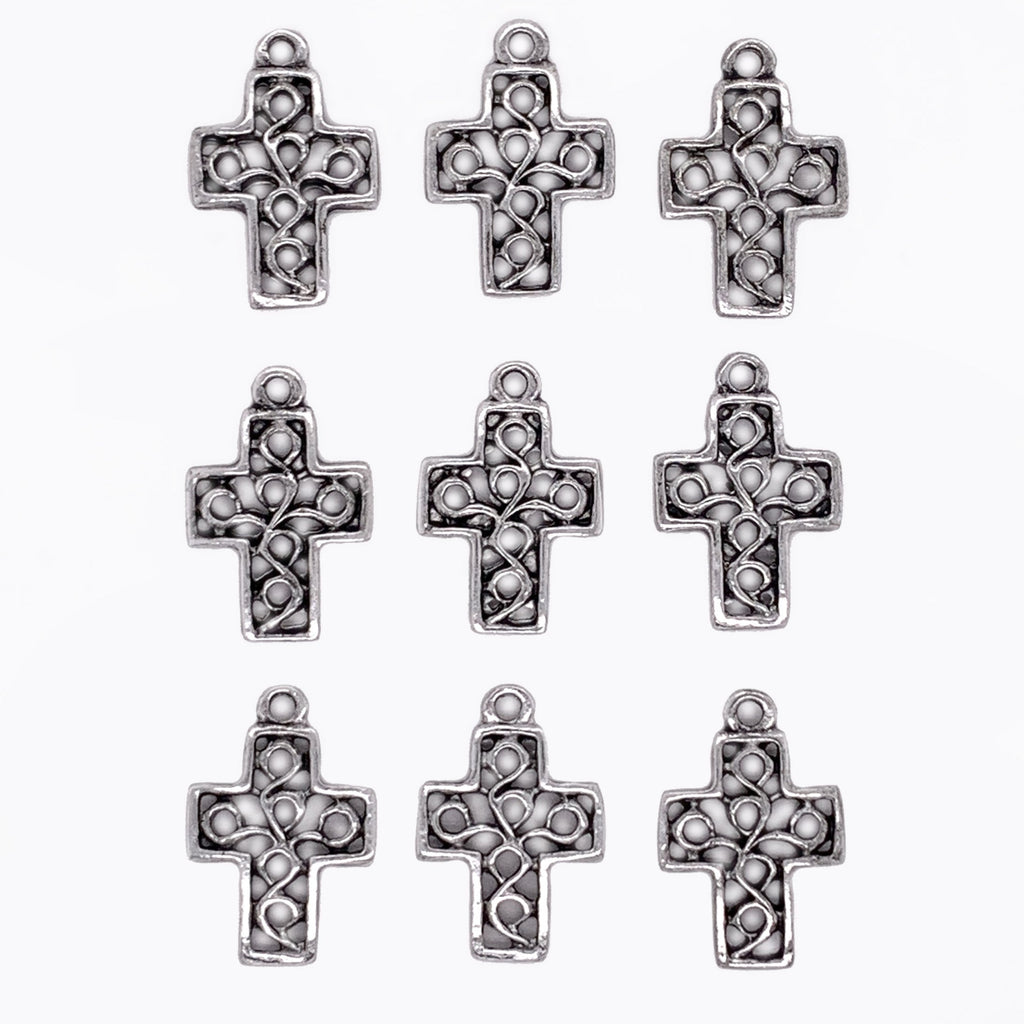 Silver cross-shaped pendants on a white background