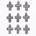 Silver cross-shaped pendants on a white background