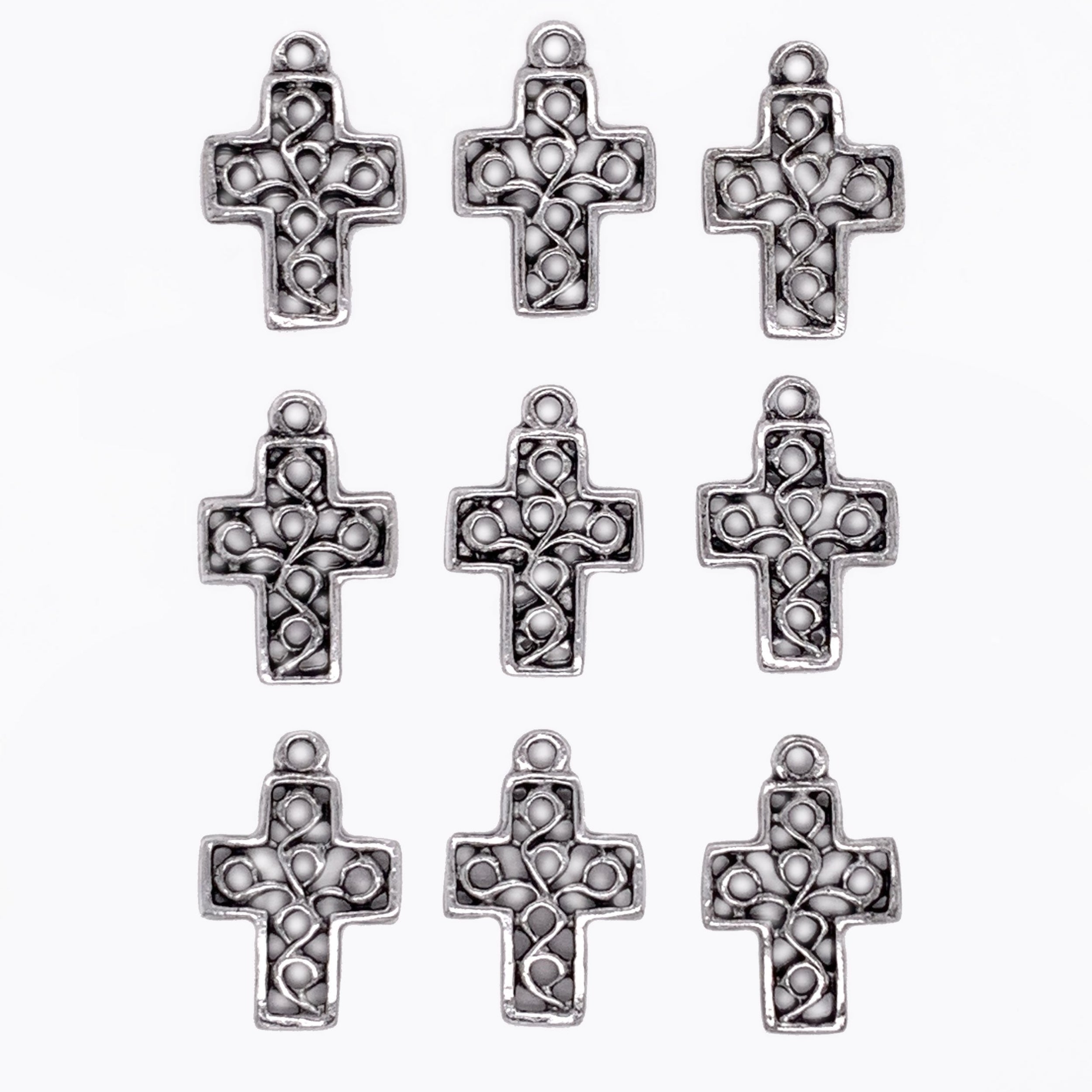 Silver cross-shaped pendants on a white background