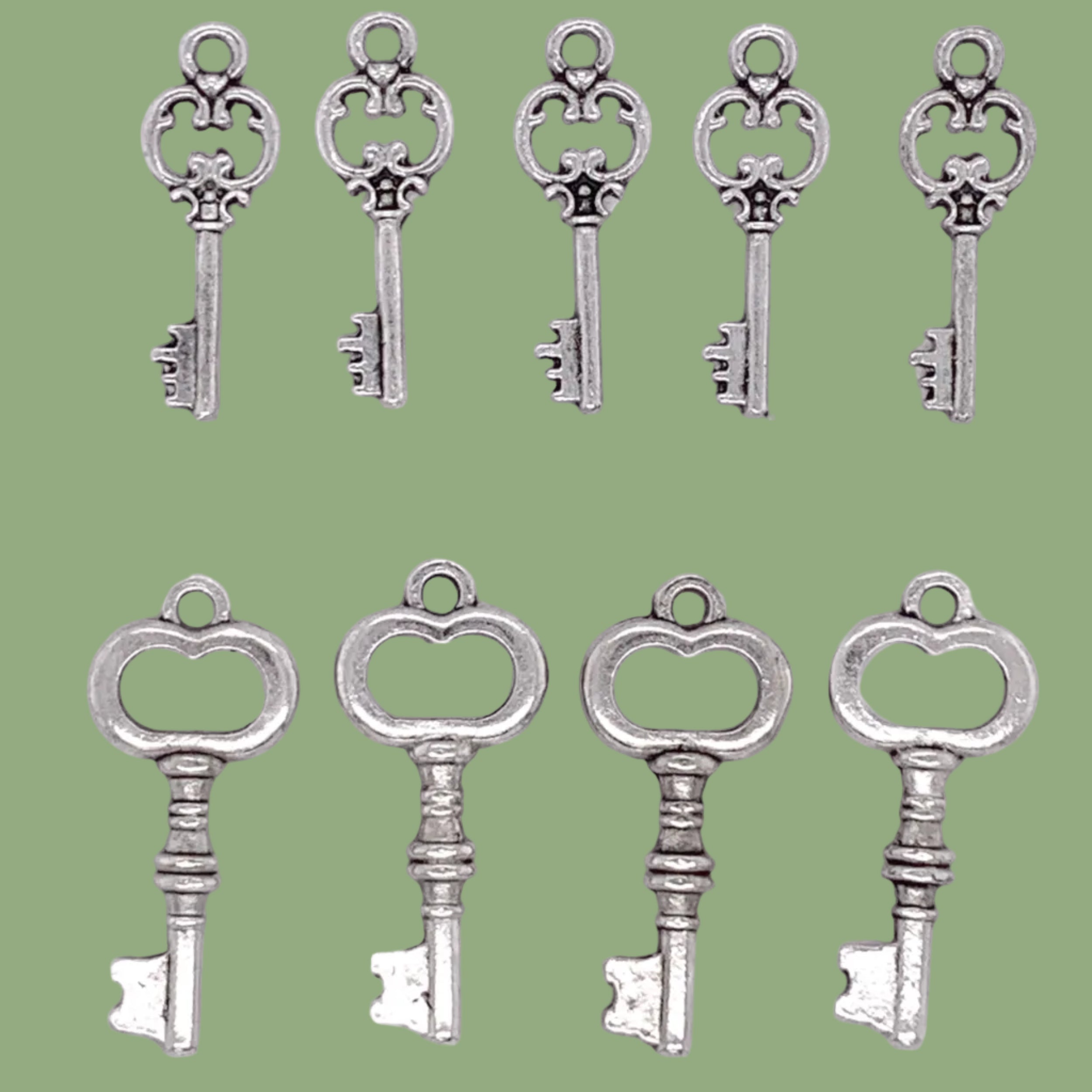 Set of silver key-shaped charms on a white background