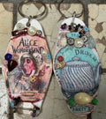 A pair of hand decorated retro motel keyrings.