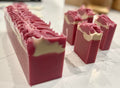 Pink and white soap bars on a marble surface