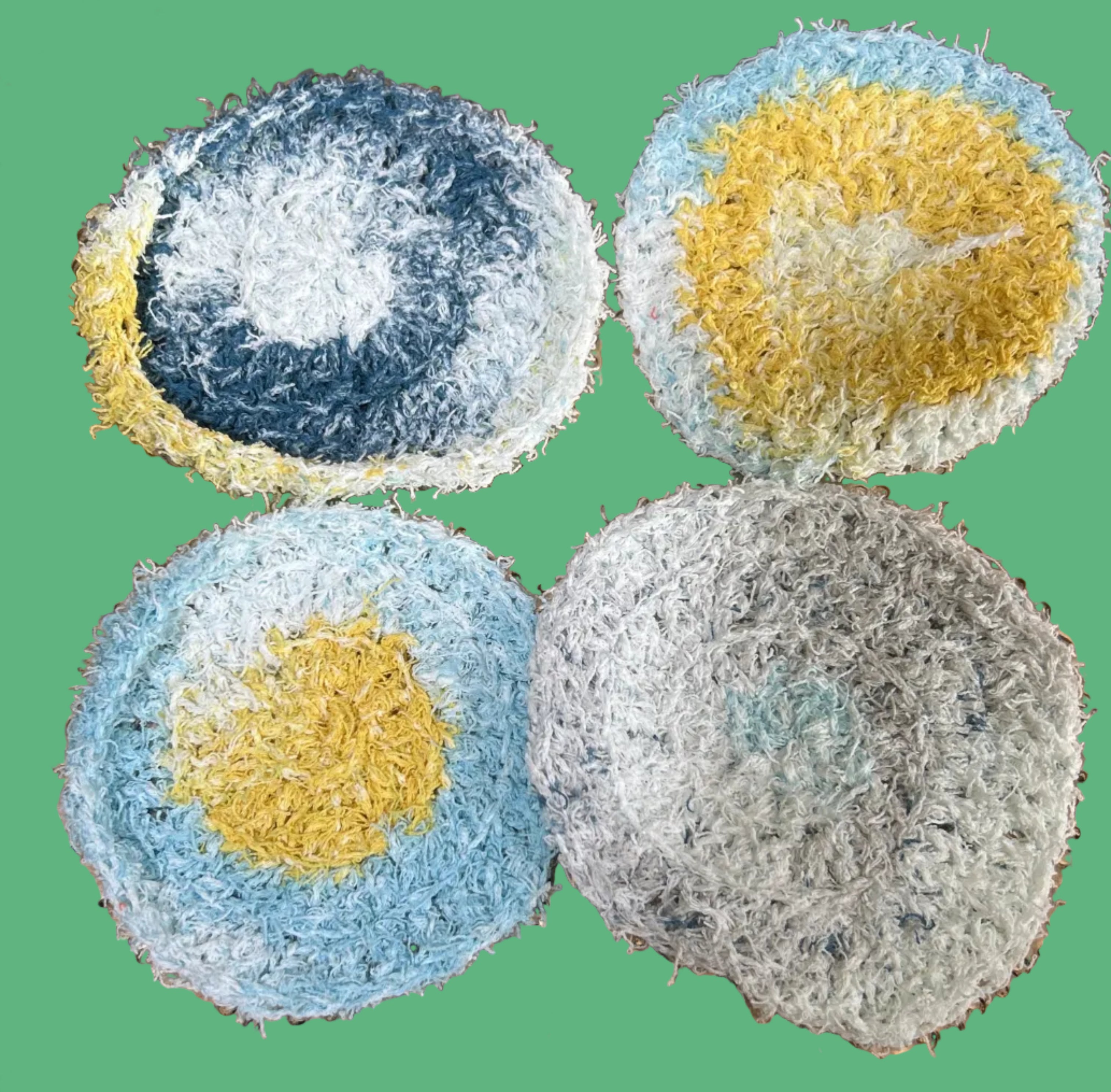 Four multicolored scrubbies on a textured gold plate