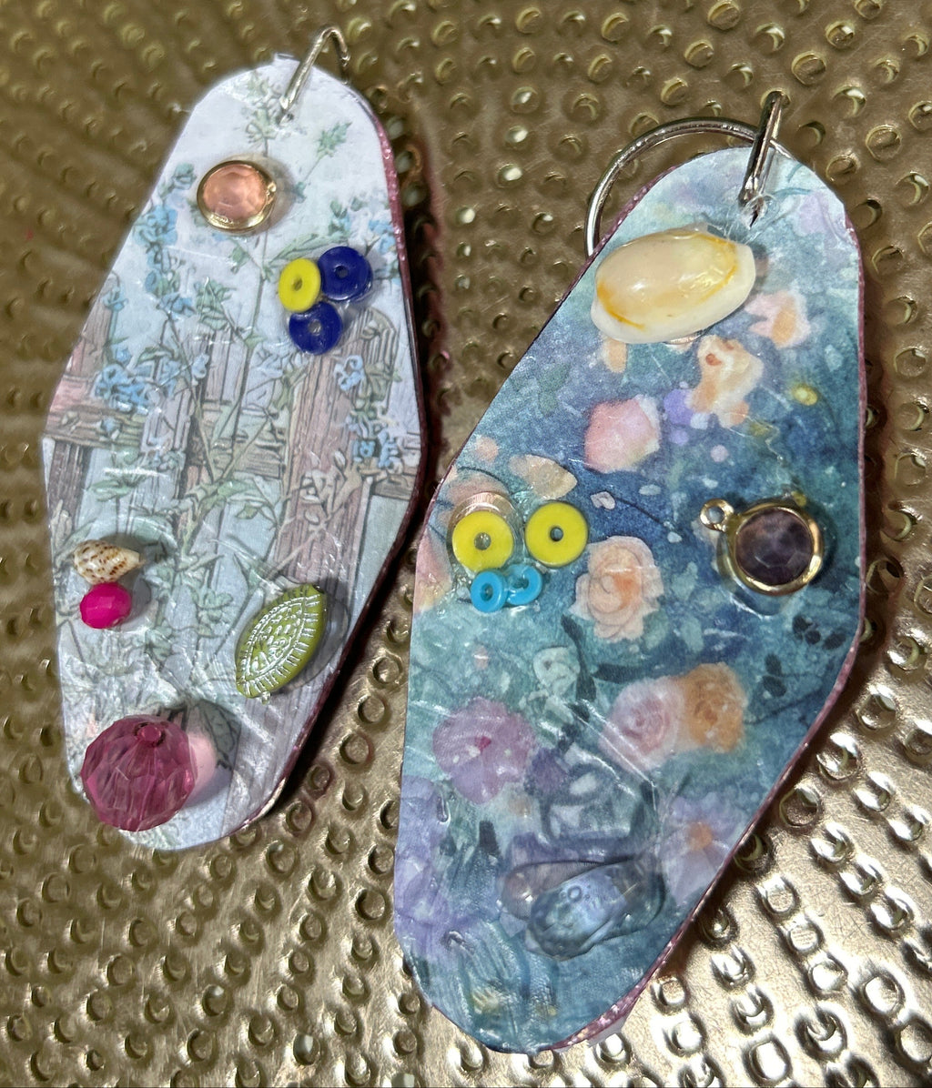 Two colorful fishing lures on a textured metallic surface