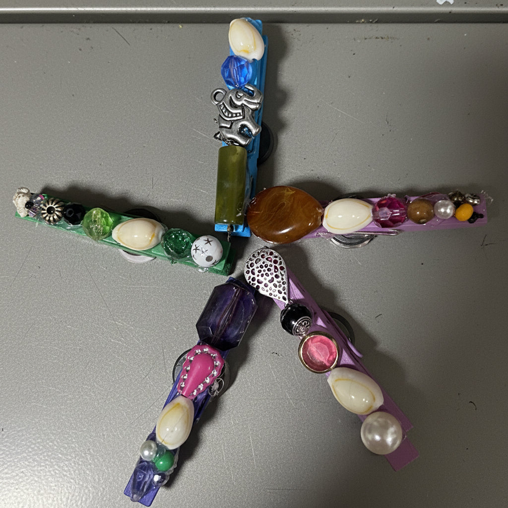 Decorative cross with colorful beads on a pink plastic surface
