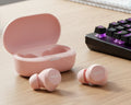 Pink wireless earbuds with charging case on a white background