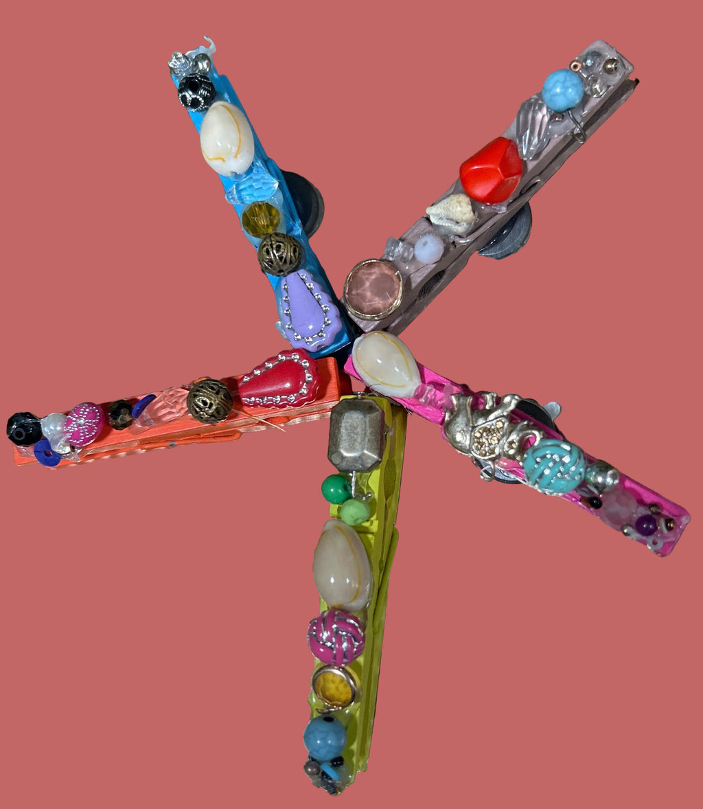 Colorful dragonfly-shaped object on a textured metallic surface