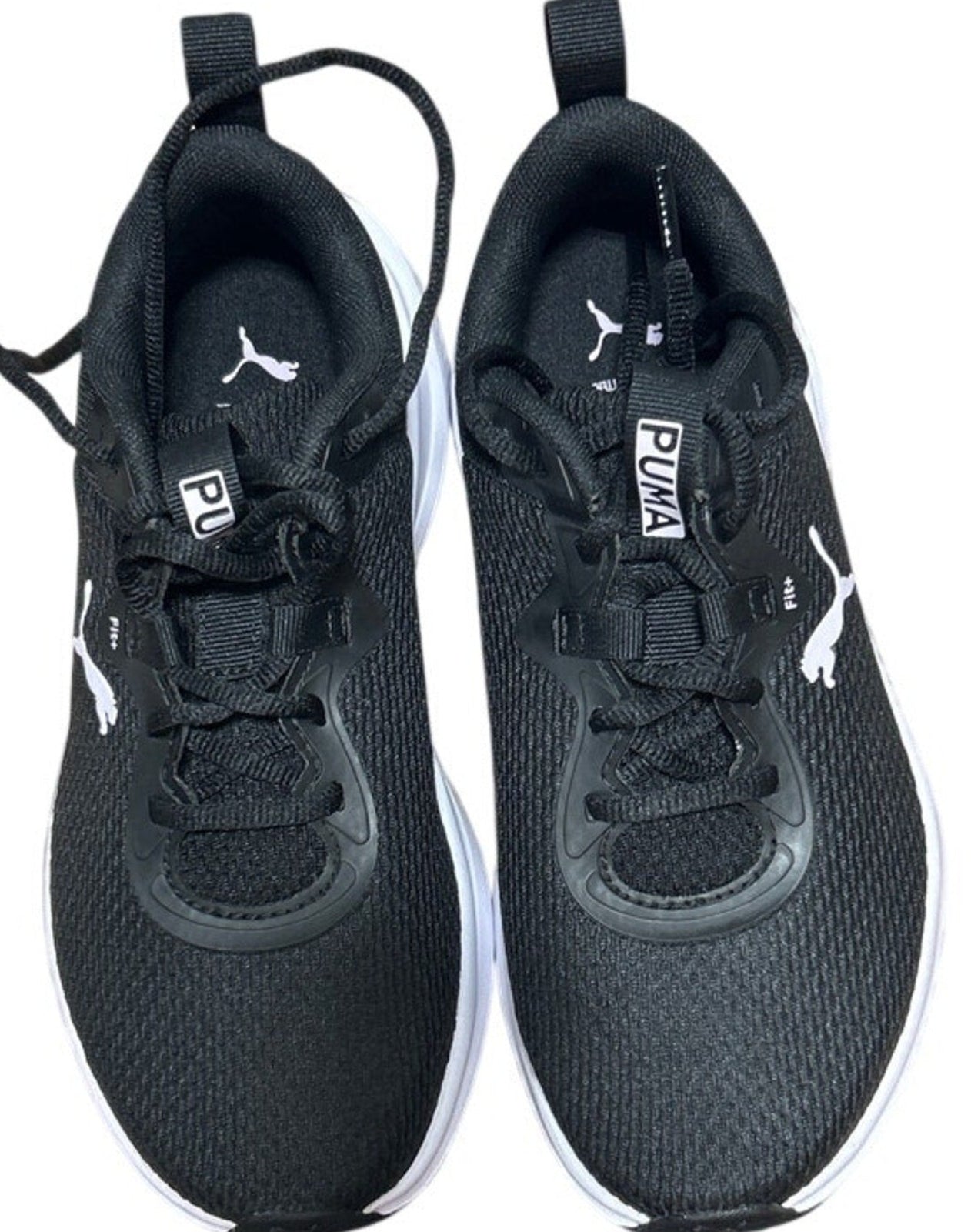 Pair of black Puma sneakers on a white background