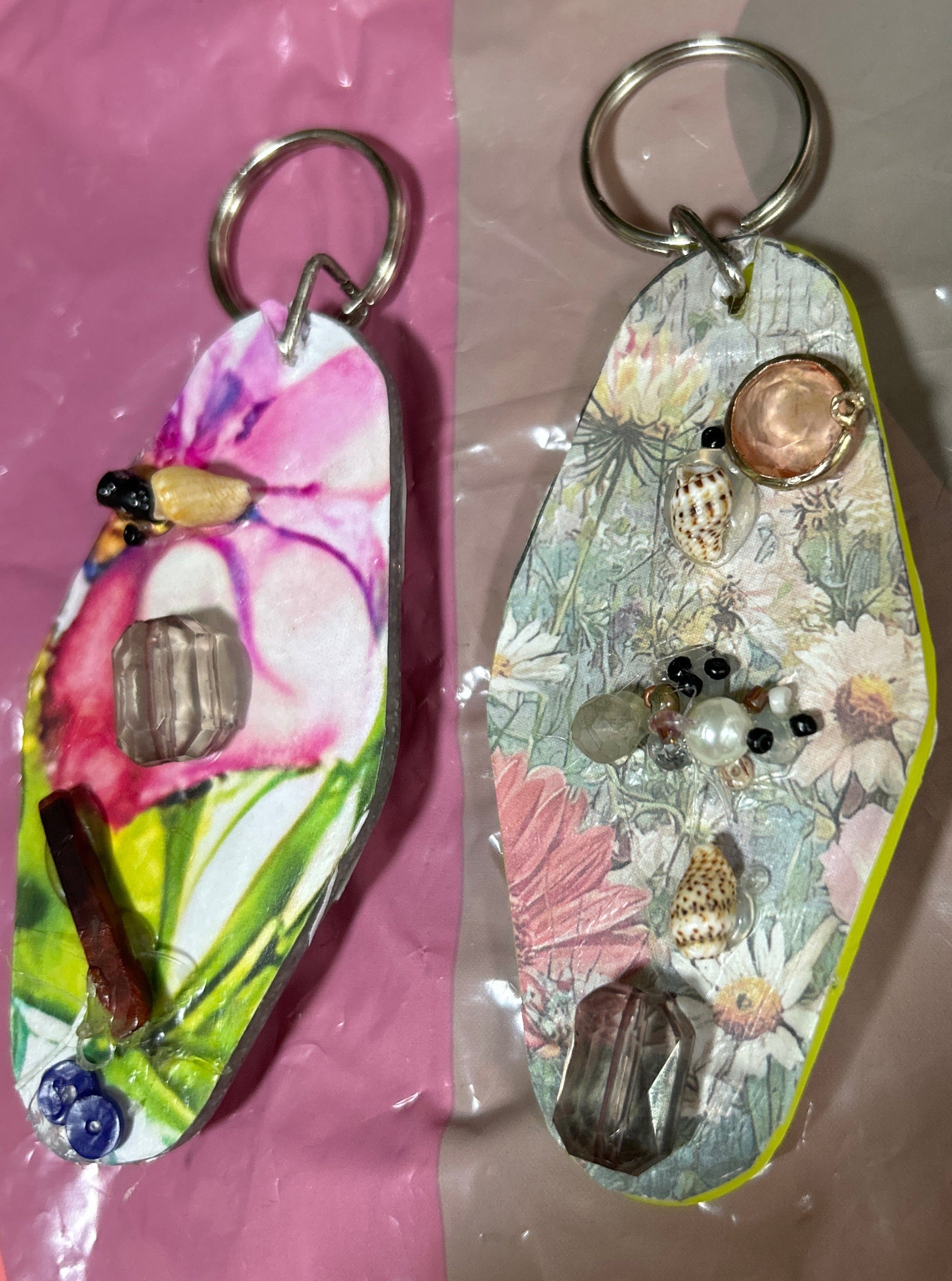Keychain with decorative elements on a pink surface