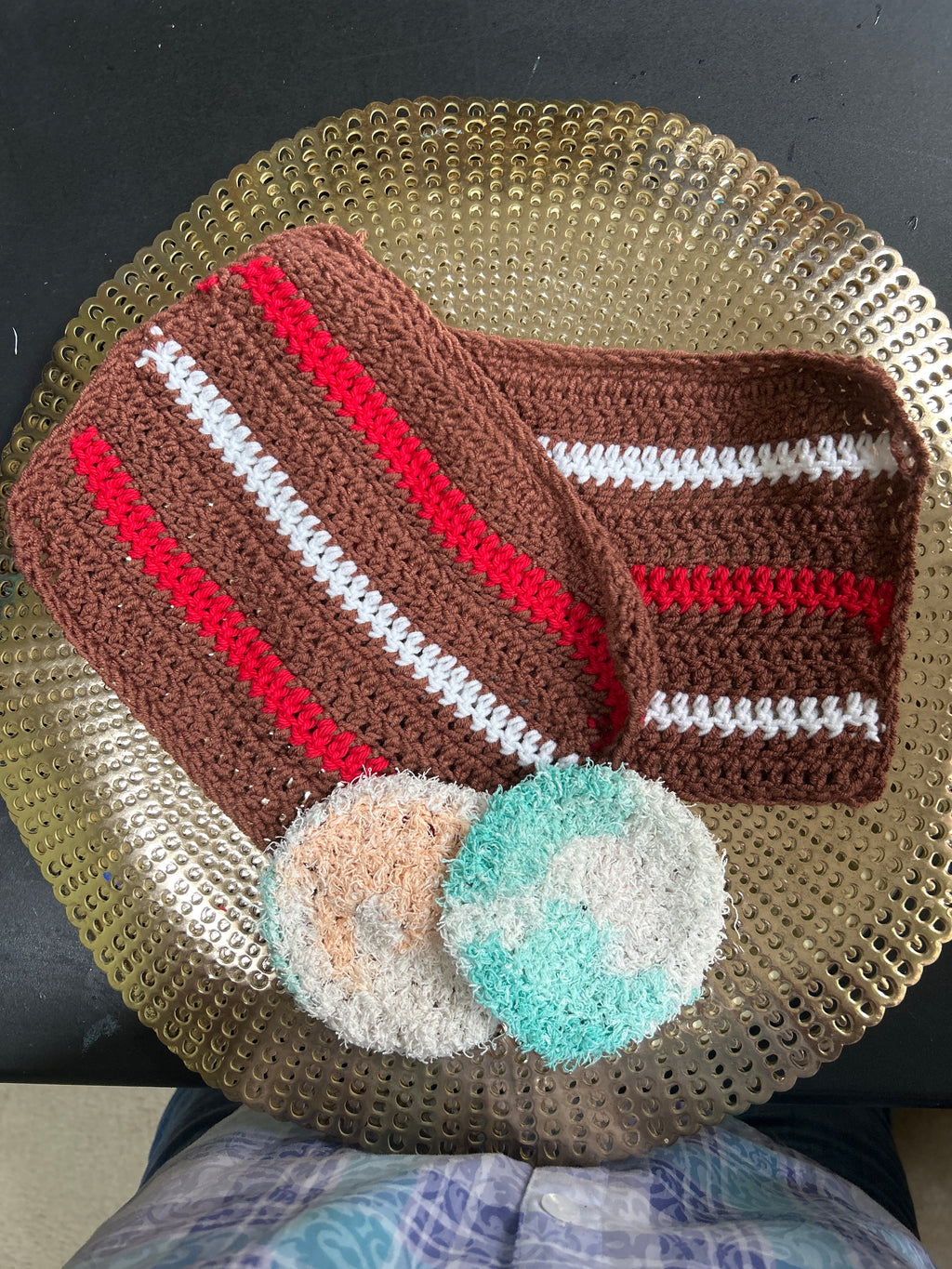 A pair of handmade crocheted wash cloths with 2 facial scrubbies.
