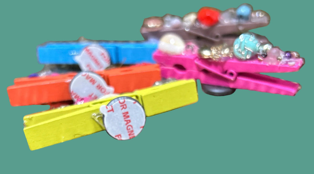 Colorful magnetic clips attached to a metallic surface