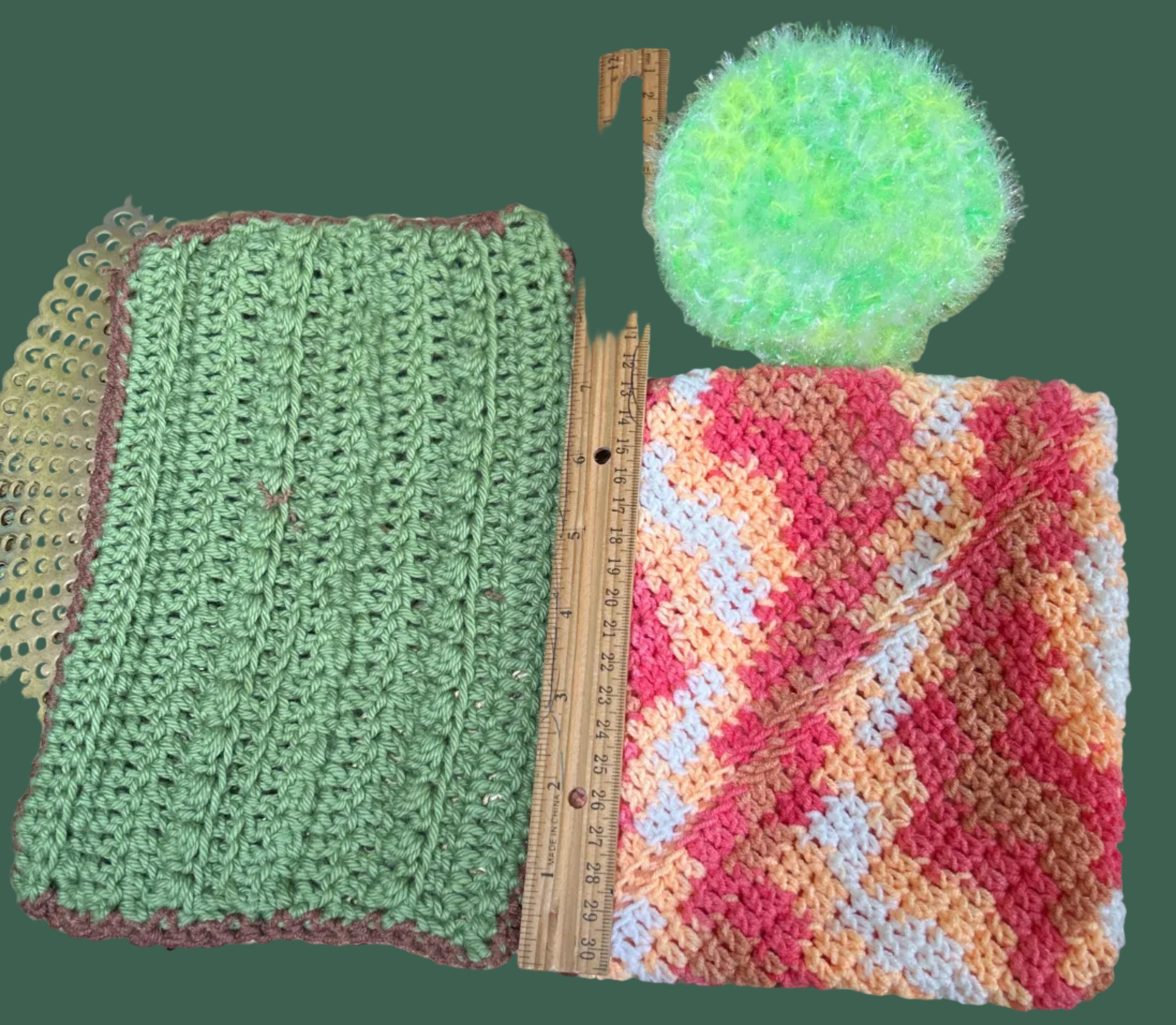 Three crocheted items on a textured surface with a ruler for scale.