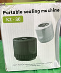 Box of a portable sealing machine on a green surface