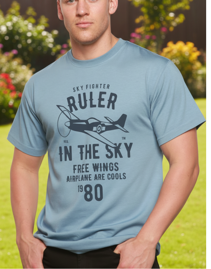 Man wearing a light blue t-shirt with text and airplane graphic on a white background