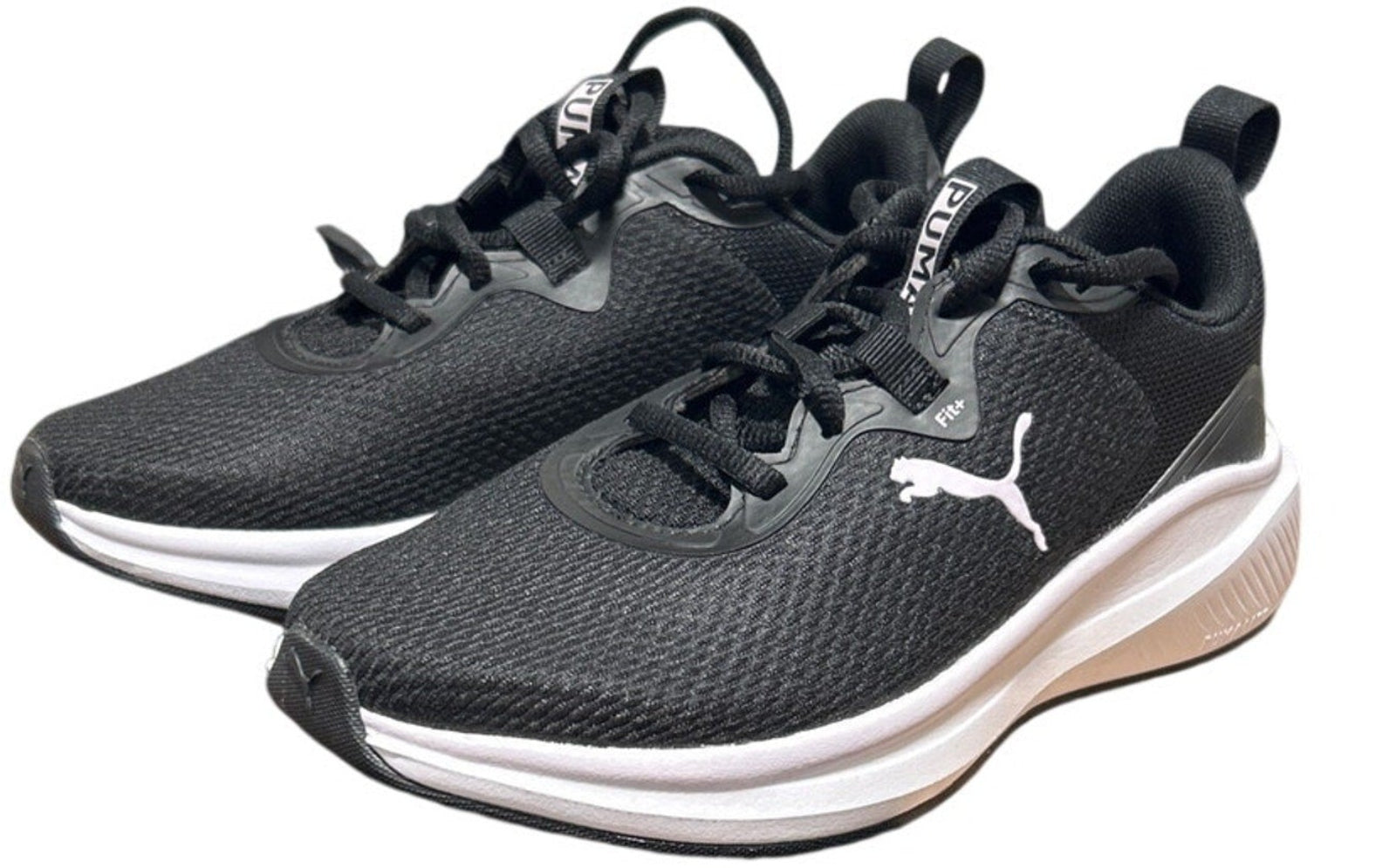 Pair of black running shoes with a visible brand logo on a white background