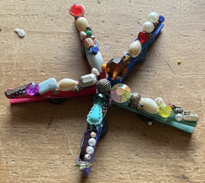 Colorful beaded star-shaped object on a textured metallic surface