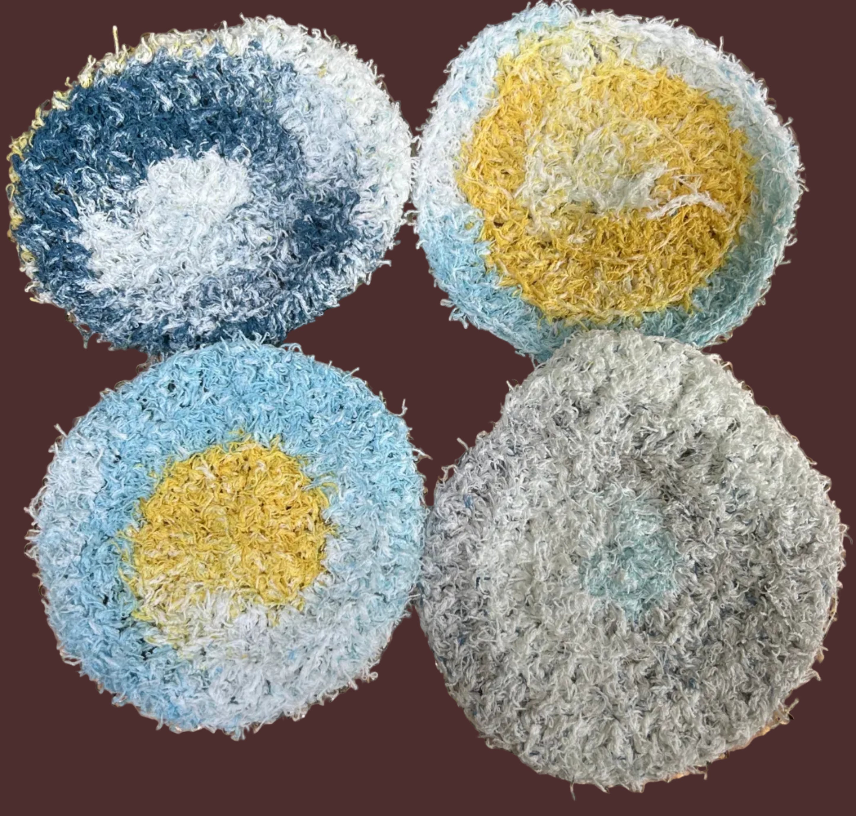 Four multicolored scrubbies on a textured gold surface