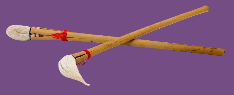 Two wooden brushes with white bristles on a white background