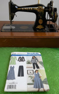 Simplicity sewing pattern package for Khaliah Ali Collection on a green textured background