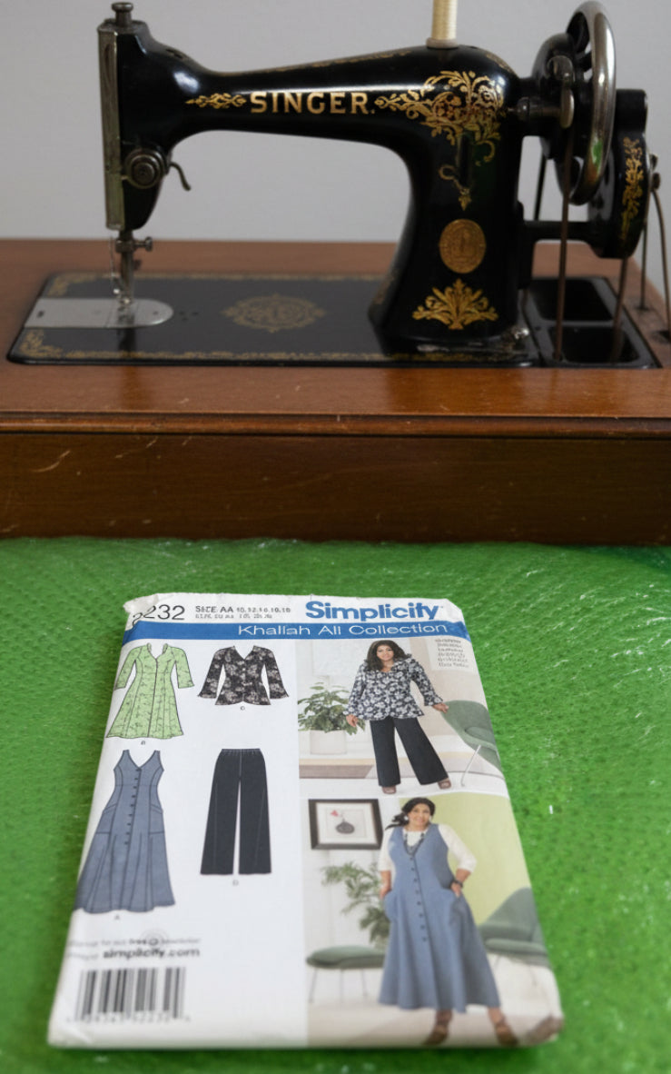 Simplicity sewing pattern package for Khaliah Ali Collection on a green textured background