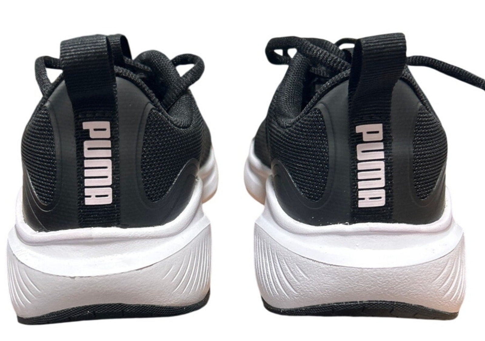 Black and white Puma sneakers on a white background