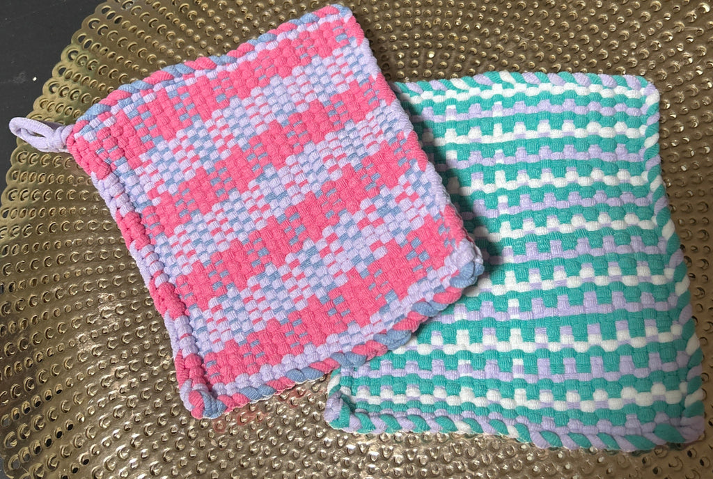 Two checkered cloth pads on a textured surface