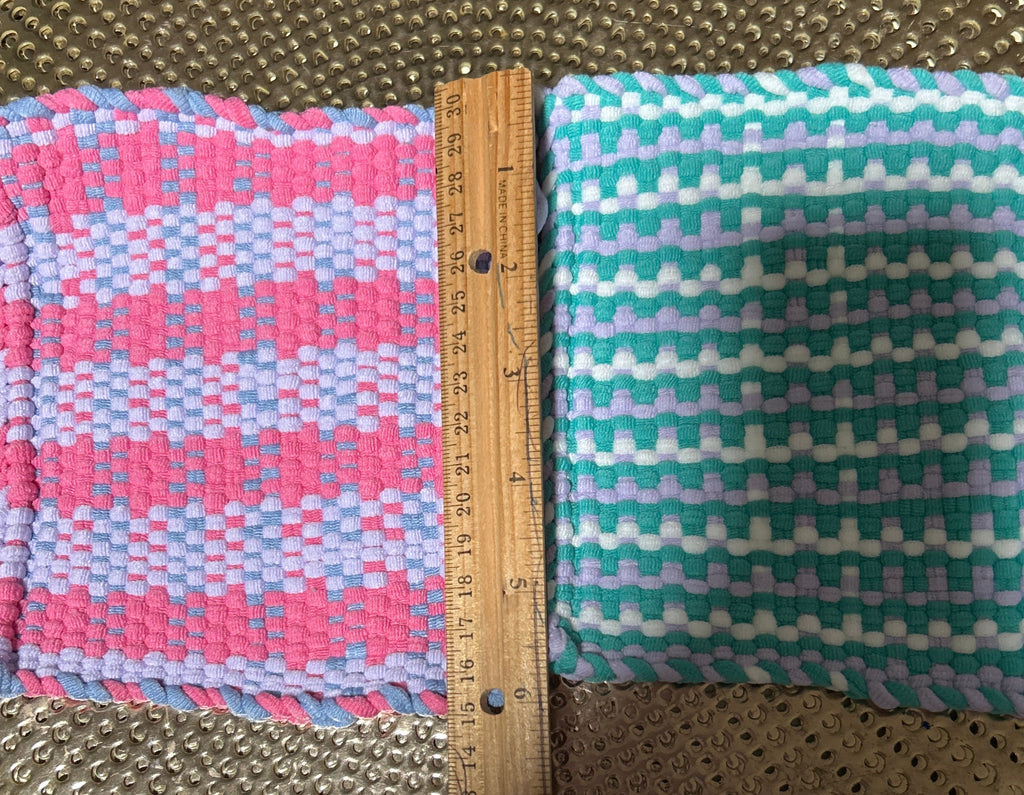 Two fabric swatches on a textured surface with a ruler for scale.