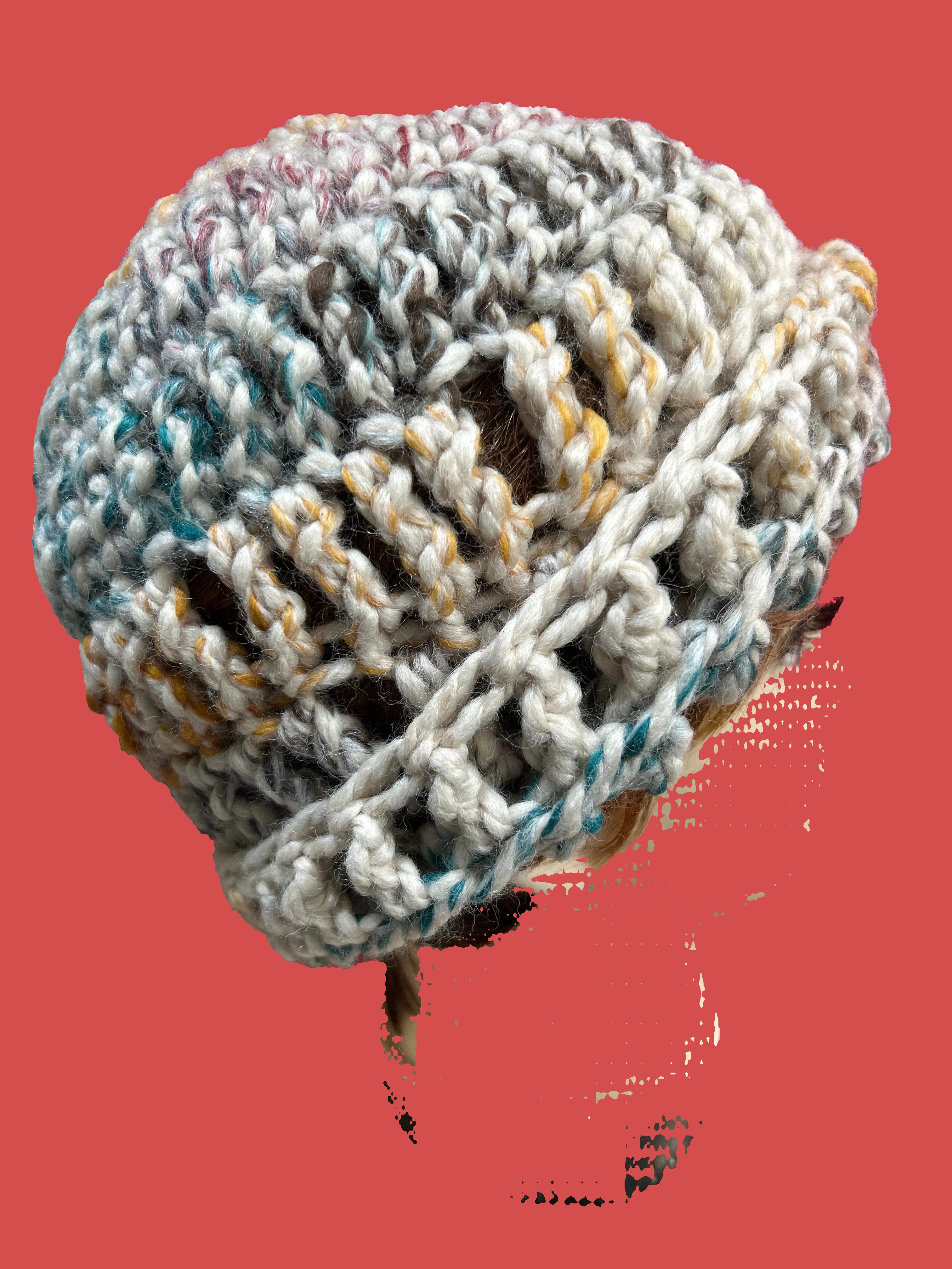 Knitted ball on a brush with a pink background