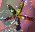Colorful beaded star-shaped object on a reflective surface