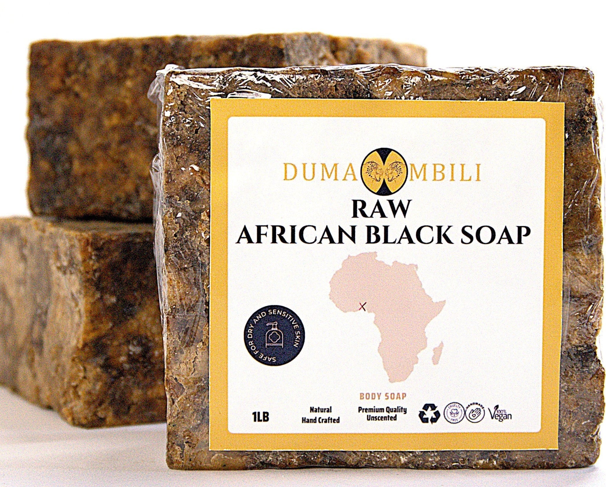 Raw African black soap with Dumaombili packaging on a white background