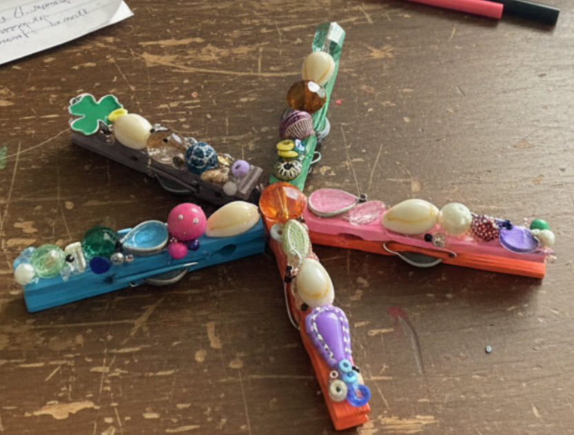 Colorful beaded dragonfly on a textured metallic surface