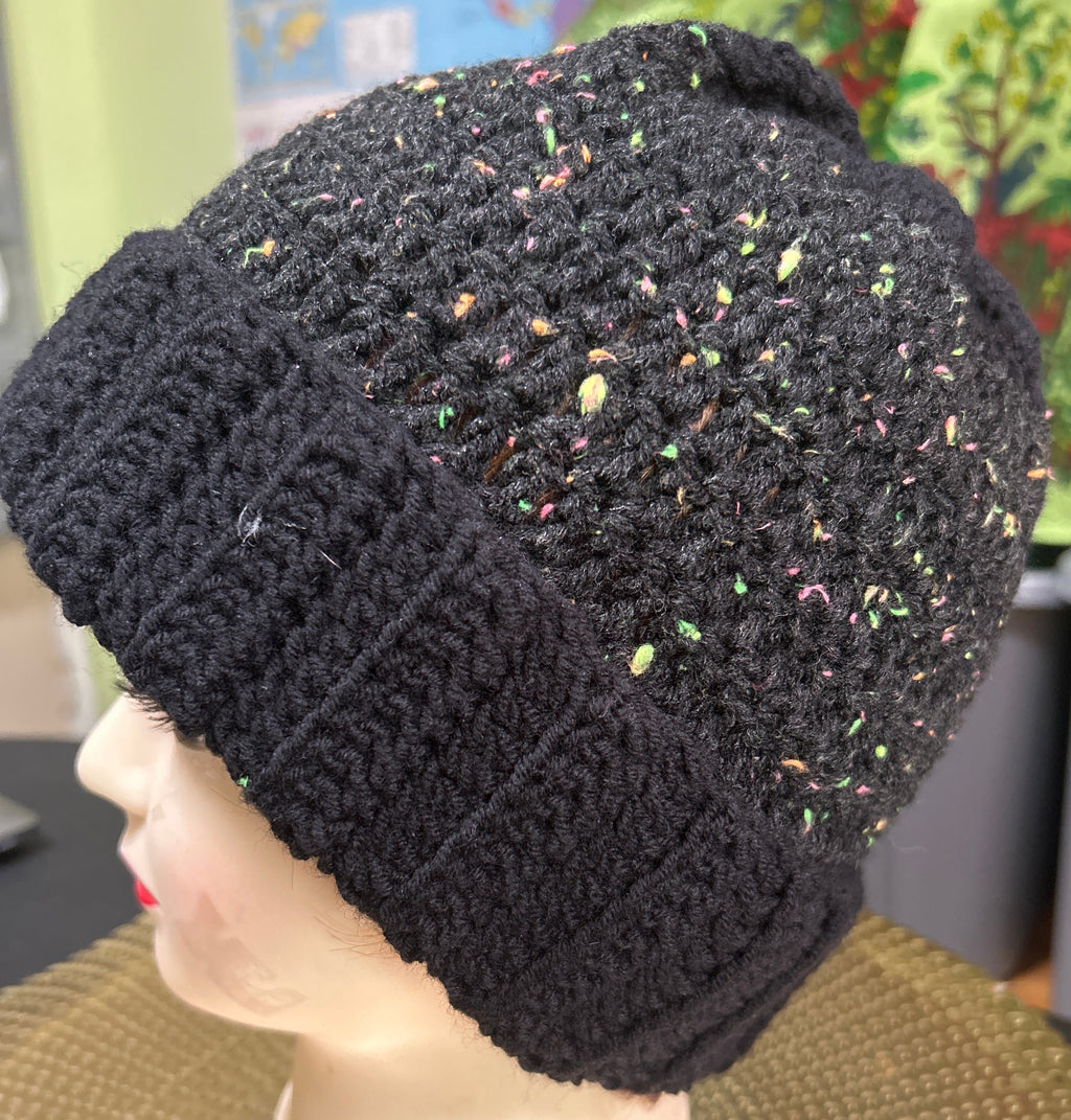 Black textured beanie on a mannequin head with a colorful background
