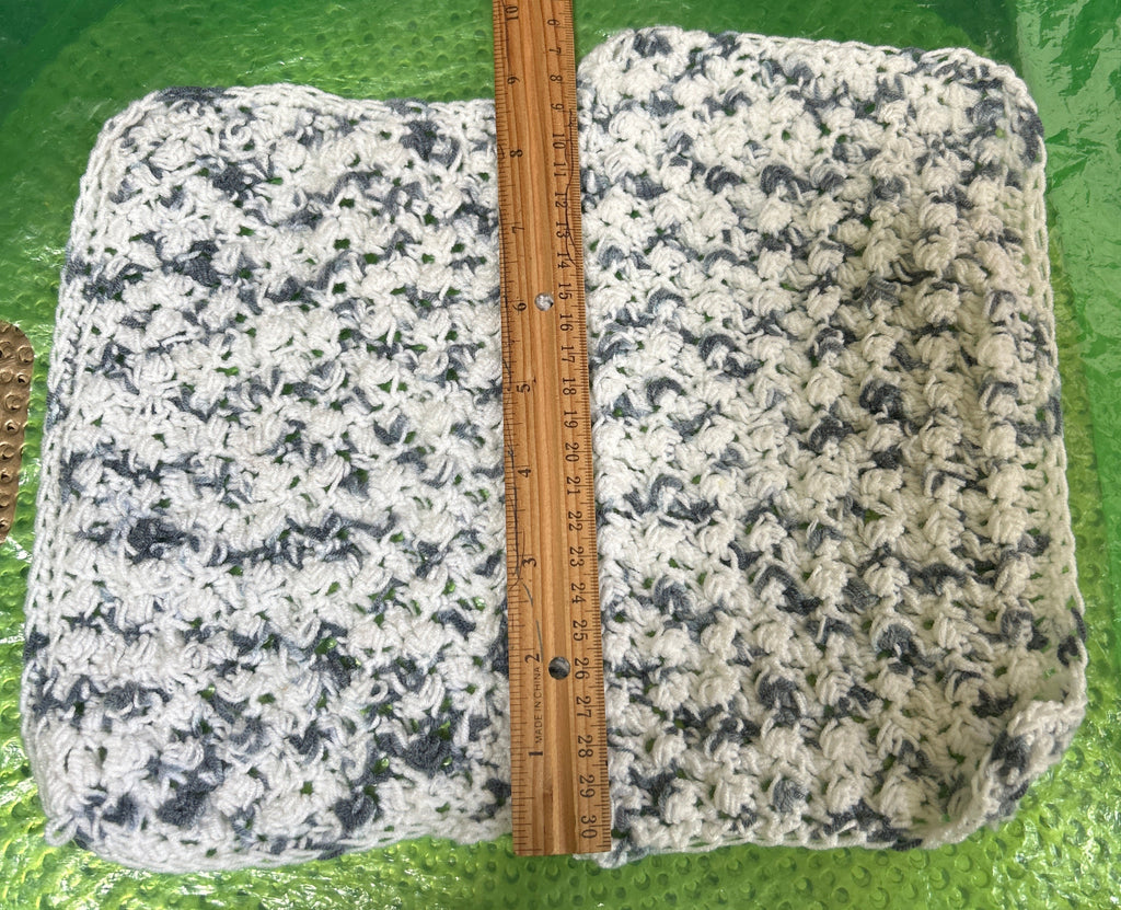 Two slabs of granite with a ruler for scale on a green surface.