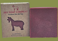 Bar of soap from Jax Soap Company next to its packaging on a white background