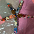 Decorative hair clip with colorful beads on a reflective surface