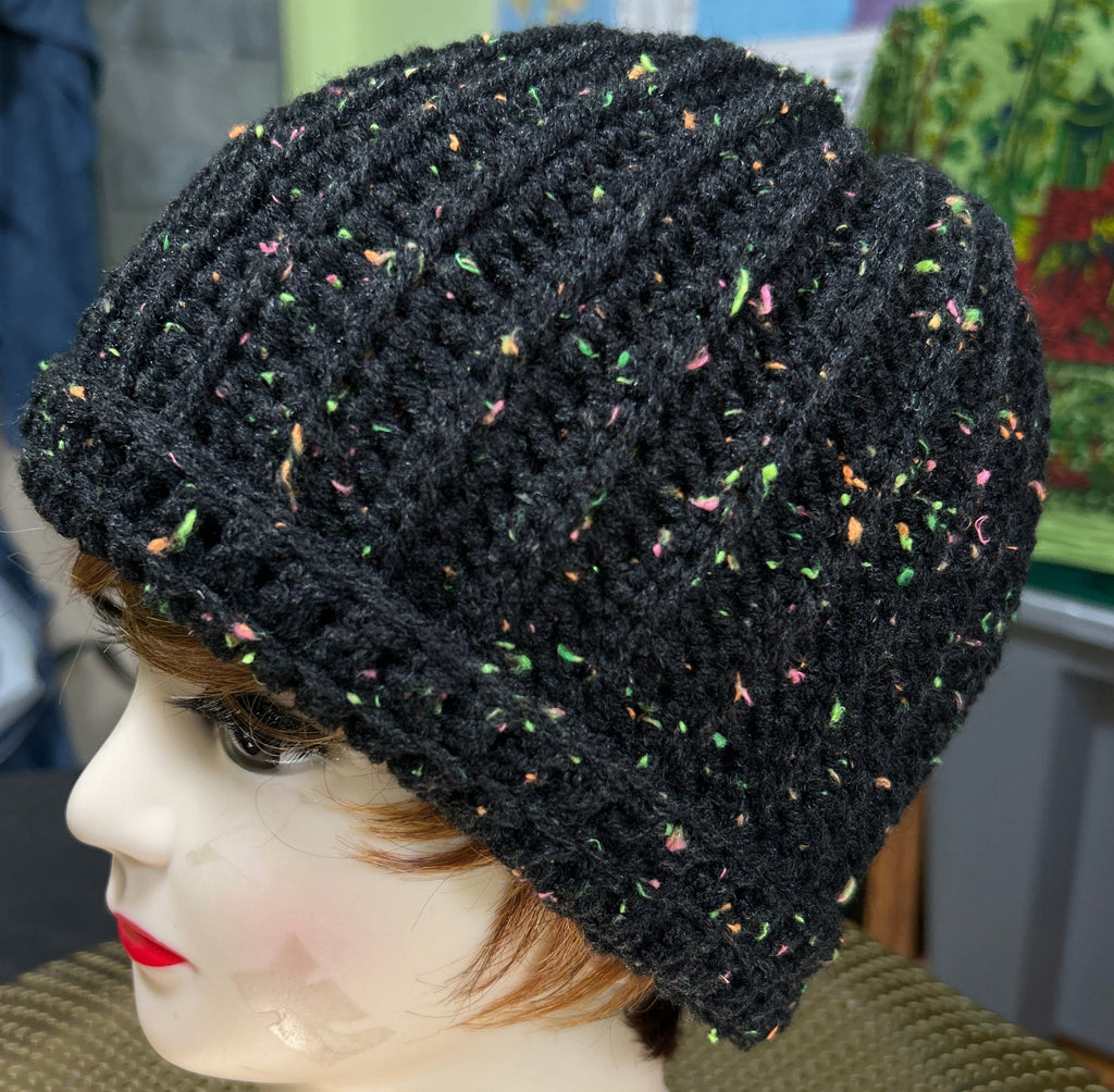 Black textured beanie on a mannequin head with a blurred background
