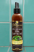 Bottle of Apple Cider Vinegar Herbal Clarifying Rinse with label on a white background
