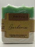 Green soap bar with a brown label on a white background
