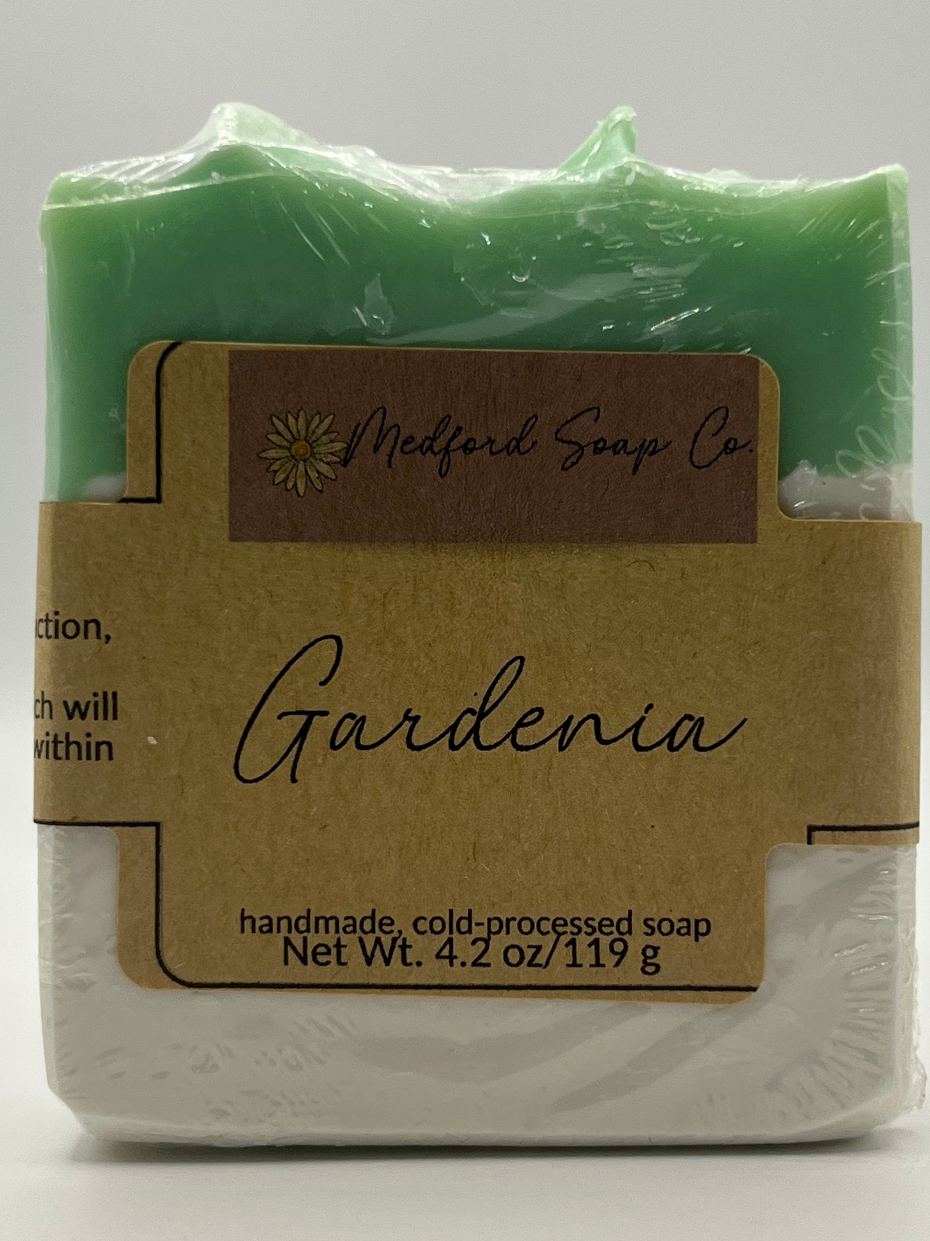 Green soap bar with a brown label on a white background