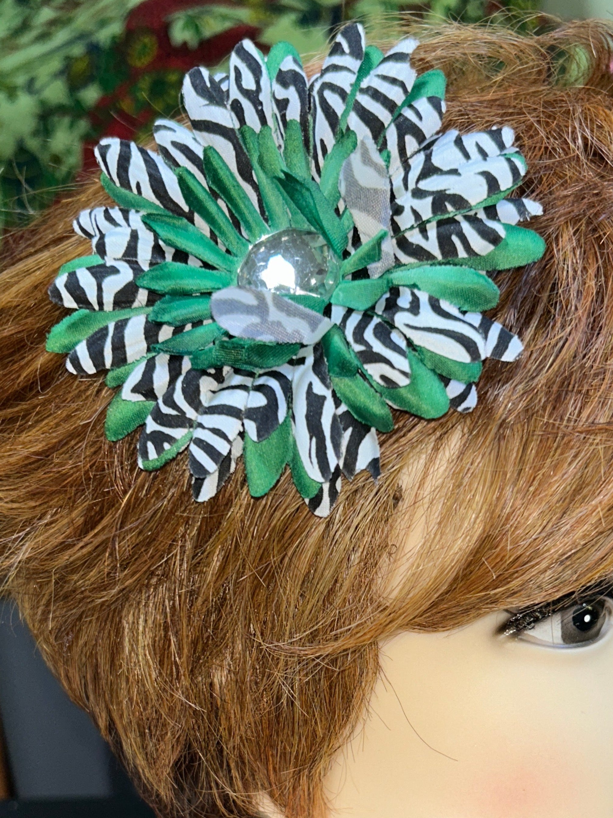 Mannequin head with brown hair and decorative flower accessory, blurred background