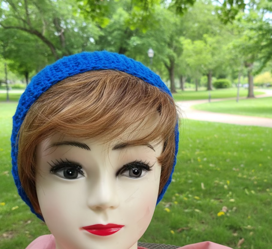 Mannequin head with blue crocheted headband in a room setting