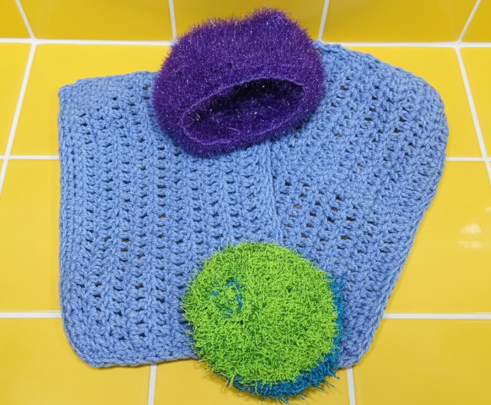 Blue and green scrubber set on a metallic surface