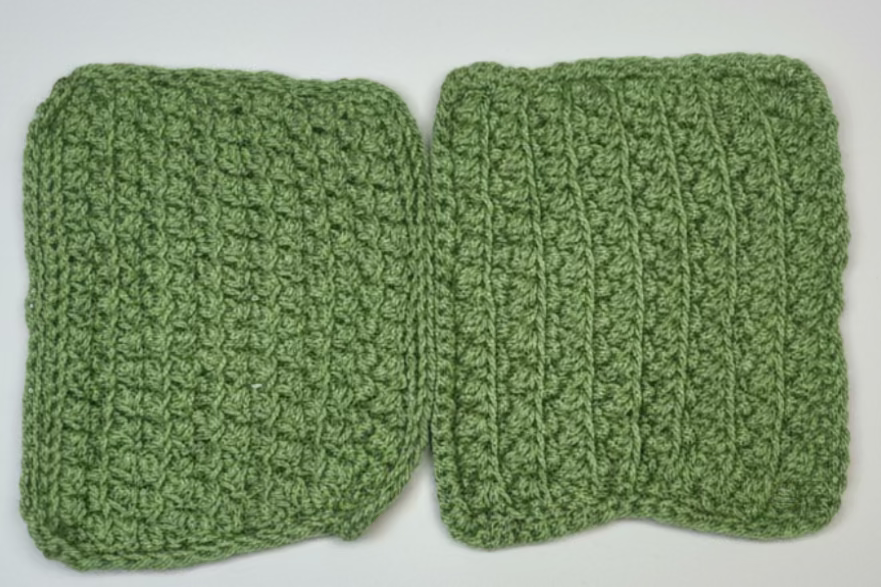 Green crocheted fabric with a wooden ruler for scale on a textured surface