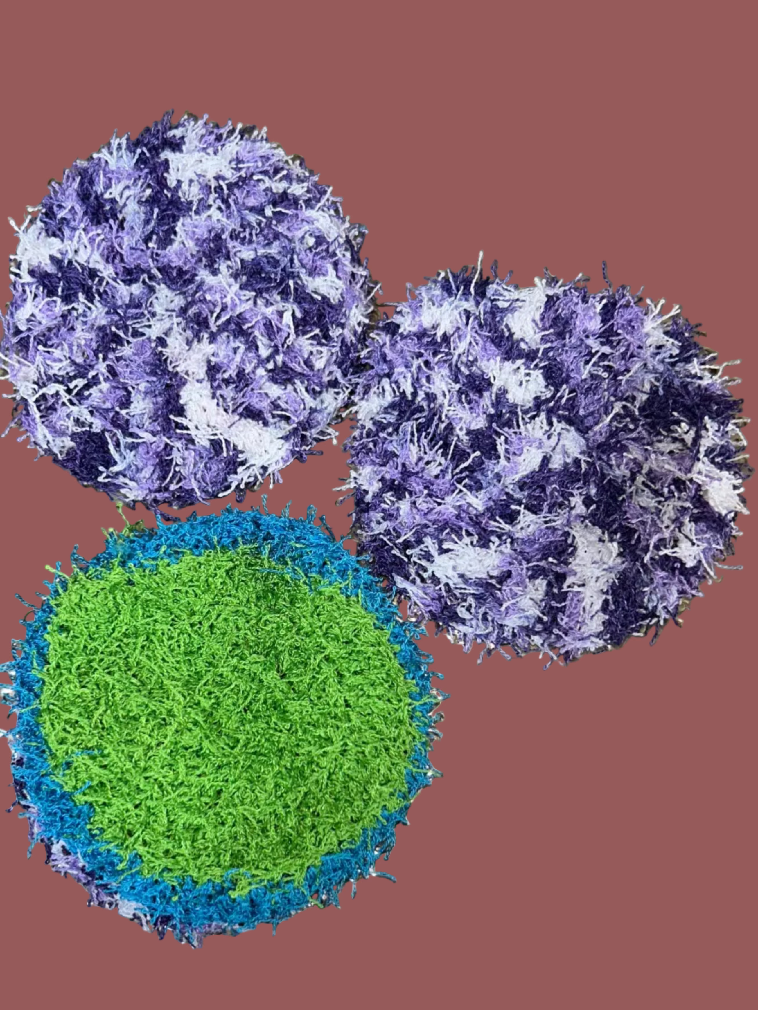 Three textured coasters, two purple and one green, on a metallic surface.
