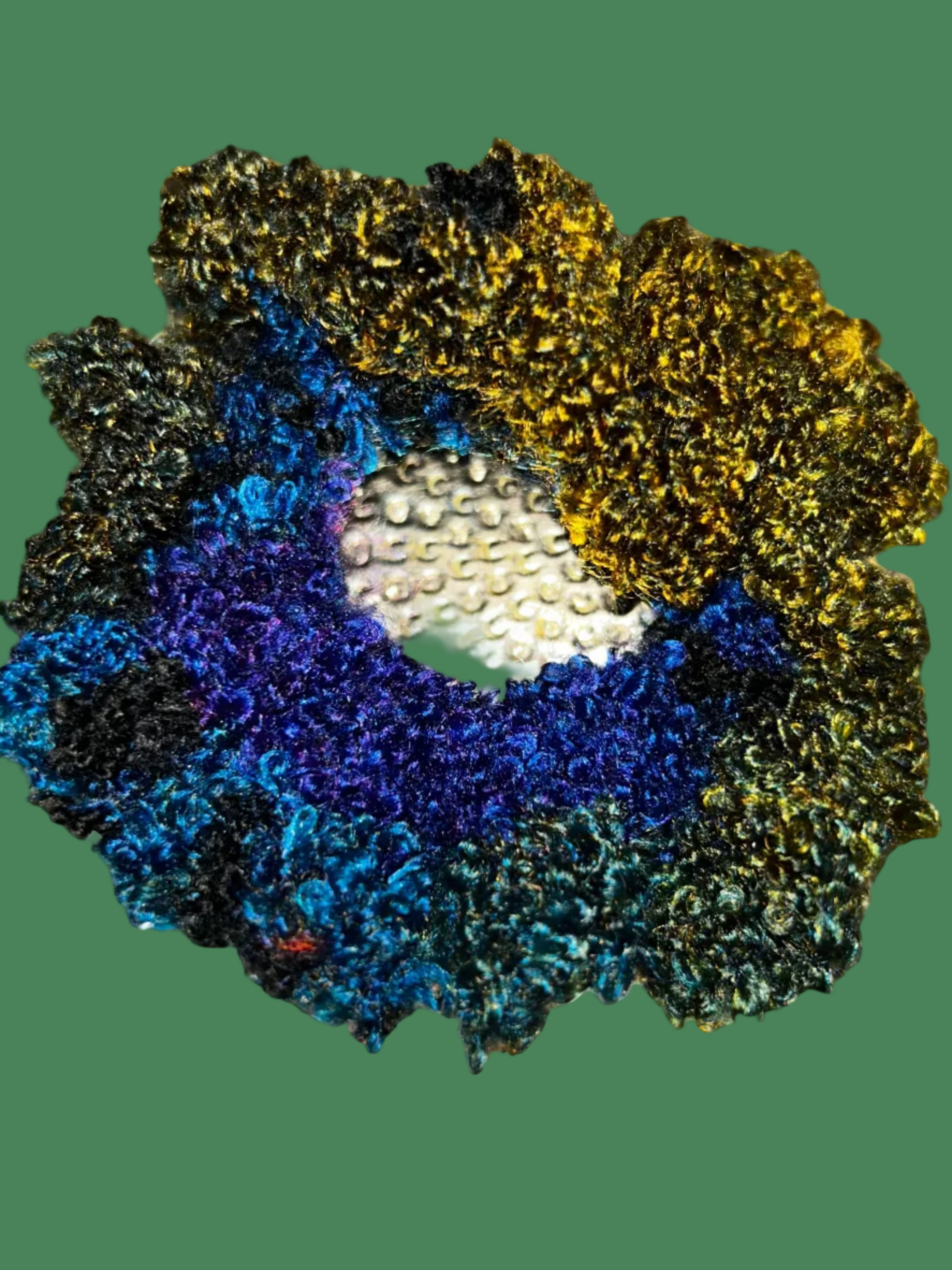 Multicolored textured scrunchie on a textured gold background