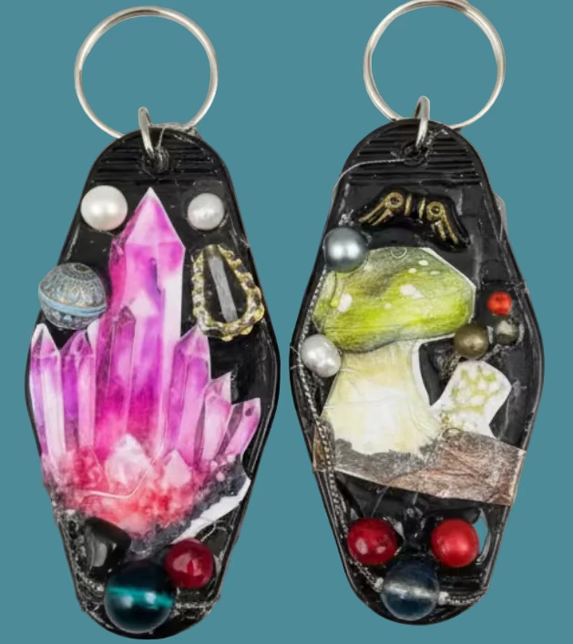 Pair of decorative earrings on a textured metallic surface