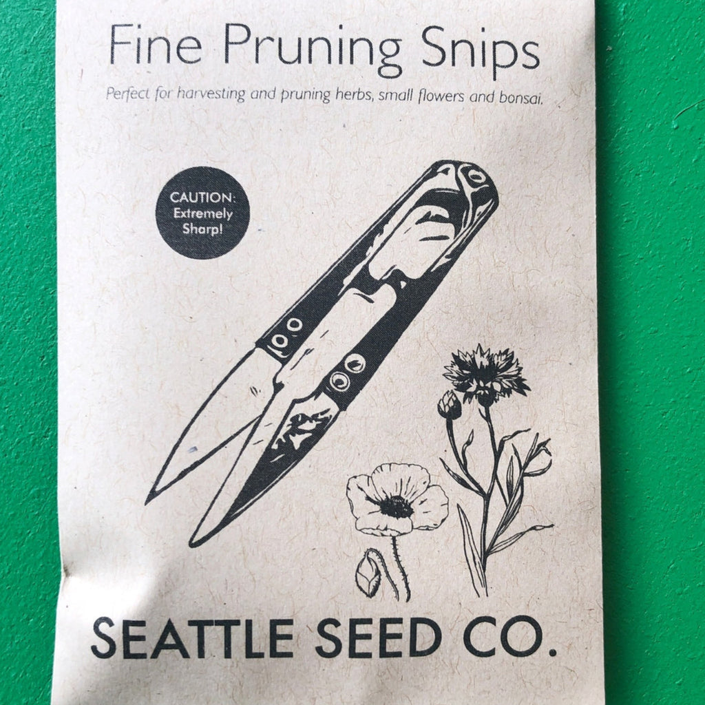 Package of 'Fine Pruning Snips' from Seattle Seed Co. on a green background